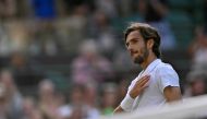 Italy's Lorenzo Musetti celebrates winning against US player Taylor Fritz during their men's singles quarter-finals tennis match on the tenth day of the 2024 Wimbledon Championships at The All England Lawn Tennis and Croquet Club in Wimbledon, southwest London, on July 10, 2024. (Photo by Andrej Isakovic / AFP) 