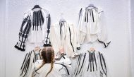 A woman from Sibiu region arranges traditional blouses at an exhibition of traditional Romanian Blouses in Vaideeni village, south-central Romania, on June 29, 2024. (Photo by Daniel Mihailescu / AFP)
