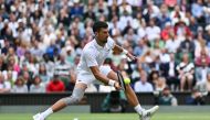 Serbia's Novak Djokovic returns against Italy's Lorenzo Musetti on July 12, 2024. (Photo by Andrej Isakovic / AFP) 
 