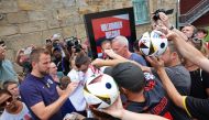 England's forward #09 Harry Kane signs autographs as he leaves the media centre on July 12, 2024. (Photo by Adrian Dennis / AFP)