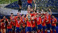 Spain's players celebrate with the trophy after winning the UEFA Euro 2024 final football match between Spain and England at the Olympiastadion in Berlin on July 14, 2024. (Photo by Tobias SCHWARZ / AFP)
