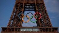 This photograph shows the Eiffel Tower, decorated with the Olympic rings for the upcoming Paris 2024 Olympic Games, in Paris, on July 18, 2024. (Photo by EMMANUEL DUNAND / AFP)