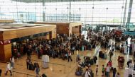 Travelers wait, following a global outage impacting computer systems at Berlin Brandenburg Airport in Berlin on Friday, July 19. (Photo: Liesa Johannssen/Bloomberg)