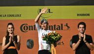 UAE Team Emirates team's Slovenian rider Tadej Pogacar celebrates on the podium after winning the 20th stage of the 111th edition of the Tour de France cycling race, 132,8 km between Nice and Col de la Couillole, southeastern France, on July 20, 2024. (Photo by Marco BERTORELLO / AFP)
