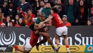 South Africa's wing Makazole Mapimpi (C) is tackled by Portugal's centre Tomas Appleton (L) and Portugal's full-back Simao Bento (R) during the International rugby union match between South Africa and Portugal at the Toyota Stadium in Bloemfontein on July 20, 2024. (Photo by Phill Magakoe / AFP)
