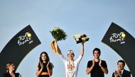 UAE Team Emirates team's Slovenian rider Tadej Pogacar celebrates on the podium after winning the 21st and final stage of the 111th edition of the Tour de France cycling race, a 33,7 km individual time-trial between Monaco and Nice, on July 21, 2024. (Photo by Marco BERTORELLO / AFP)
