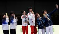 Gold medalists Yuting Huang and Lihao Sheng of Team China (L), Silver medalists Hajun Park and Jihyeon Keum of Team Republic of Korea (L) and Bronze medalists Alexandra Le and Islam Satpayev of Team Kazakhstan (R) take a selfie on the podium during the Shooting medal ceremony on July 27, 2024. (Photo by ALAIN JOCARD / AFP)