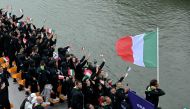 Italy's delegation with Italy's flag bearer Gianmarco Tamberi (R) sails on a boat during the opening ceremony of the Paris 2024 Olympic Games in Paris on July 26, 2024. (Photo by Damien MEYER / AFP)
