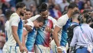 France's Antoine Dupont (C) and teammates celebrate after the men's gold medal rugby sevens match between France and Fiji during the Paris 2024 Olympic Games at the Stade de France in Saint-Denis on July 27, 2024. (Photo by CARL DE SOUZA / AFP)
