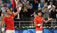 Spain's Rafael Nadal (L) and Spain's Carlos Alcaraz (R) celebrate after beating Argentina's Maximo Gonzalez and Argentina's Andres Molteni in their men's doubles first round tennis match on Court Philippe-Chatrier at the Roland-Garros Stadium at the Paris 2024 Olympic Games, in Paris on July 27, 2024. (Photo by MARTIN BERNETTI / AFP)
