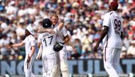 England's captain Ben Stokes celebrates (C) with England's Ben Duckett (L) after winning on the third day of the third Test cricket match between England and West Indies at Edgbaston in Birmingham, central England on July 28, 2024.. (Photo by Darren Staples / AFP) 