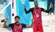 Qatar’s Ahmed Tijan (left) and Cherif Younousse celebrate after scoring a point in the men’s pool A beach volleyball match against Italy's Paolo Nicolai and Samuele Cottafava. AFP