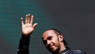 Mercedes' British driver Lewis Hamilton waves as he arrives for the podium ceremony after the Formula One Belgian Grand Prix at the Spa-Francorchamps Circuit in Spa on July 28, 2024. (Photo by SIMON WOHLFAHRT / AFP)
 