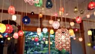 Lamps shaded with mizuhiki creations hang from the ceiling at the museum in Kanazawa. (Photo by The Japan News)