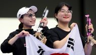 Silver medalist, South Korea's Kim Ye-ji (L) and gold medalist South Korea's Oh Ye Jin, react at the end of the 10m air pistol women's Final during the Paris 2024 Olympic Games at Chateauroux Shooting Centre on July 28, 2024. (Photo by Alain Jocard / AFP)