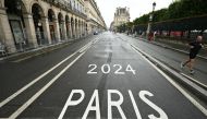 A man runs along Rue de Rivoli, which has been temporarily blocked off due to the Paris 2024 Olympic Games, in Paris on July 27, 2024. (Photo by Kirill KUDRYAVTSEV / AFP)
