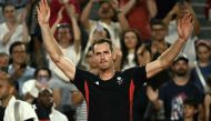 Britain's Andy Murray waves goodbye after playing with Britain's Daniel Evans against US' Taylor Fritz and US' Tommy Paul in their men's doubles quarter-final tennis match on Court Suzanne-Lenglen at the Roland-Garros Stadium during the Paris 2024 Olympic Games, in Paris on August 1, 2024. (Photo by Carl De Souza / AFP)