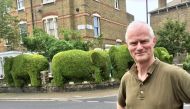 Tim Bushe with the elephant hedges in North London that he cut in 2012. (Courtesy of Tim Bushe)