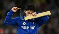 Philippines' Carlos Edriel Yulo celebrates winning the gold medal during the podium ceremony for the artistic gymnastics men's floor exercise during the Paris 2024 Olympic Games at the Bercy Arena in Paris, on August 3, 2024. (Photo by Lionel BONAVENTURE / AFP)
