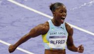 St Lucia's Julien Alfred celebrates after winning the women's 100m final of the athletics event at the Paris 2024 Olympic Games at Stade de France in Saint-Denis, north of Paris, on August 3, 2024. (Photo by Odd ANDERSEN / AFP)
