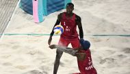 Qatar’s Ahmed Tijan (right) digs the ball beside Cherif Younousse during their Round of 16 match against Chile. AFP