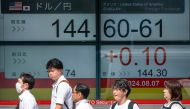 People walk past an electronic quotation board displaying the exchange rate for the Japanese yen against the US dollar in Tokyo on August 7, 2024. Photo by Kazuhiro NOGI / AFP.