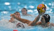 US' #01 Adrian Weinberg is marked by Hungary's #05 Marton Vamos in the men's water polo bronze medal match between the USA and Hungary during the Paris 2024 Olympic Games at the Paris La Defense Arena in Paris on August 11, 2024. Photo by Andreas SOLARO / AFP.