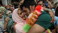 Arshad Nadeem (R), Pakistan's javelin gold medallist at the Paris 2024 Olympic Games, hugs his mother Raziah Parveen upon his arrival at his hometown in Mian Channu on August 11, 2024. (Photo by AFP)
