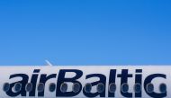 This general view shows the logo on the fuselage of an airBaltic aircraft at Riga International Airport in Riga on April 10, 2020, Latvian airline airBaltic, the largest client in Europe for the Airbus A220-300, has ordered another 10 of the jets, the manufacturer said August 13, 2024. Photo by Gints Ivuskans / AFP