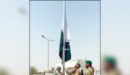 Pakistan Ambassador H E Muhemmed Aejaz hoisting the Pakistan flag at the ceremony.