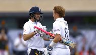 England's Ollie Pope celebrates reaching his century with Joe Root Action Images via Reuters/Andrew Boyers

