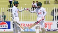 Bangladesh's Mushfiqur Rahim (R) and Mehidy Hasan Miraz bump their fists during the fourth day of the first Test cricket match between Pakistan and Bangladesh at the Rawalpindi Cricket Stadium in Rawalpindi on August 24, 2024. (Photo by Farooq NAEEM / AFP)
