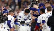 Shohei Ohtani #17 of the Los Angeles Dodgers celebrates with teammates after hitting a walk-off grand slam home run during the ninth inning against the Tampa Bay Rays at Dodger Stadium on August 23, 2024 in Los Angeles, California. (Photo by Katelyn Mulcahy / GETTY IMAGES NORTH AMERICA / Getty Images via AFP)
