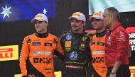 Second placed McLaren's Australian driver Oscar Piastri (L), First placed Ferrari's Monegasque driver Charles Leclerc and third placed McLaren's British driver Lando Norris (2nd R) celebrate on the podium after the Italian Formula One Grand Prix race at Autodromo Nazionale Monza circuit, in Monza on September 1, 2024. (Photo by Andrej ISAKOVIC / AFP)