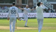 English bowler Martin Atkinson (C) celebrates after taking his fifth wicket, that of Sri Lanka's Milan Rathnayake on day four of the second cricket test match between England and Sri Lanka at Lord's cricket ground in London on September 1, 2024. (Photo by Glyn KIRK / AFP) 