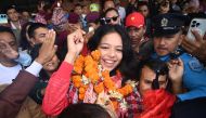 Paris 2024 Paralympic Games taekwondo bronze medallist Palesha Goverdhan greets the crowd upon her arrival at the Tribhuvan International Airport in Kathmandu on September 4, 2024. Photo by Prakash MATHEMA / AFP.