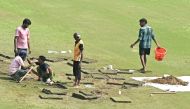 Groundsmen prepare the field with artificial grass before the start of the one-off Test between Afghanistan and New Zealand at the Shaheed Vijay Singh Pathik Sports Complex in Greater Noida. 