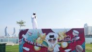 Qatari artist Mohammed AlEmadi standing on top of one of his installations.