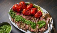 Grilled skirt steak with arugula chimichurri. (Photo by Rey Lopez for The Washington Post; food styling by Lisa Cherkasky for The Washington Post )

