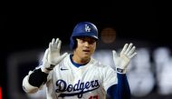 Designated hitter Shohei Ohtani #17 of the Los Angeles Dodgers celebrates as he runs the bases after hitting his 52nd career home run against starting pitcher Kyle Freeland #21 of the Colorado Rockies during the fifth inning at Dodger Stadium on September 20, 2024 in Los Angeles, California. Kevork Djansezian/Getty Images/AFP