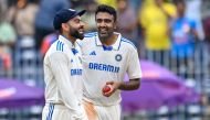 India's Ravichandran Ashwin (R) celebrates with teammate Virat Kohli after taking the wicket of Bangladesh's Mehidy Hasan Miraz on September 22, 2024. (Photo by R.Satish BABU / AFP) 