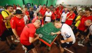 People look on as England veteran player Darren Clarke (R) takes a shot against Belgium during the Subbuteo World Cup on September 22, 2024. (Photo by Adrian Dennis / AFP)