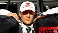 German Formula 1 driver Michael Schumacher leans between two tires on November 22, 2012 at the Interlagos racetrack in Sao Paulo, Brazil. Photo by ORLANDO KISSNER / AFP