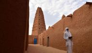 (Files) A man walks in the vicinity of a earthen mud mosque in Agadez, in northern Niger, on April 2, 2017. (Photo by Issouf Sanogo / AFP)