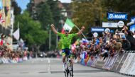 Slovenia's Tadej Pogacar celebrates as he crosses the finish line to win the men's Elite Road Race cycling event during the UCI 2024 Road World Championships, in Zurich, on September 29, 2024. (Photo by Fabrice Coffrini / AFP)