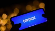 This file illustration photo taken on August 14, 2020 shows a person logging into Epic Games' Fortnite on their smartphone in Los Angeles. / AFP / Chris DELMAS

