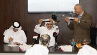 QBF General-Secretary Saadoun Sabah Al Kuwari displays a team as he takes part in the draw ceremony for the Qatar Cup yesterday. 