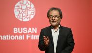 Japanese film director Kiyoshi Kurosawa gestures as he poses for photos at the 29th Busan International Film Festival (BIFF) in Busan on October 3, 2024. (Photo by Jung Yeon-je / AFP)