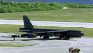 US Air Force ground crew members wave at a B-52H Stratofortress bomber as it taxis in Diego Garcia military base for take off on a strike mission against Afghanistan in Diego Garcia on October 07, 2001. (Photo by DoD / AFP)