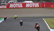 Red Bull KTM Factory Racing rider Brad Binder of South Africa (R) leads the pack during the MotoGP class practice 1 session of MotoGP Japanese Grand Prix at the Mobility Resort Motegi in Motegi, Tochigi prefecture on October 4, 2024. (Photo by Toshifumi KITAMURA / AFP)